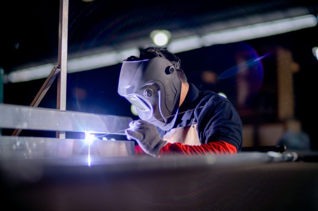 Mastering the First Impression: Your intriguing post title goes here A welder in a protective mask works on metal in an industrial setting.